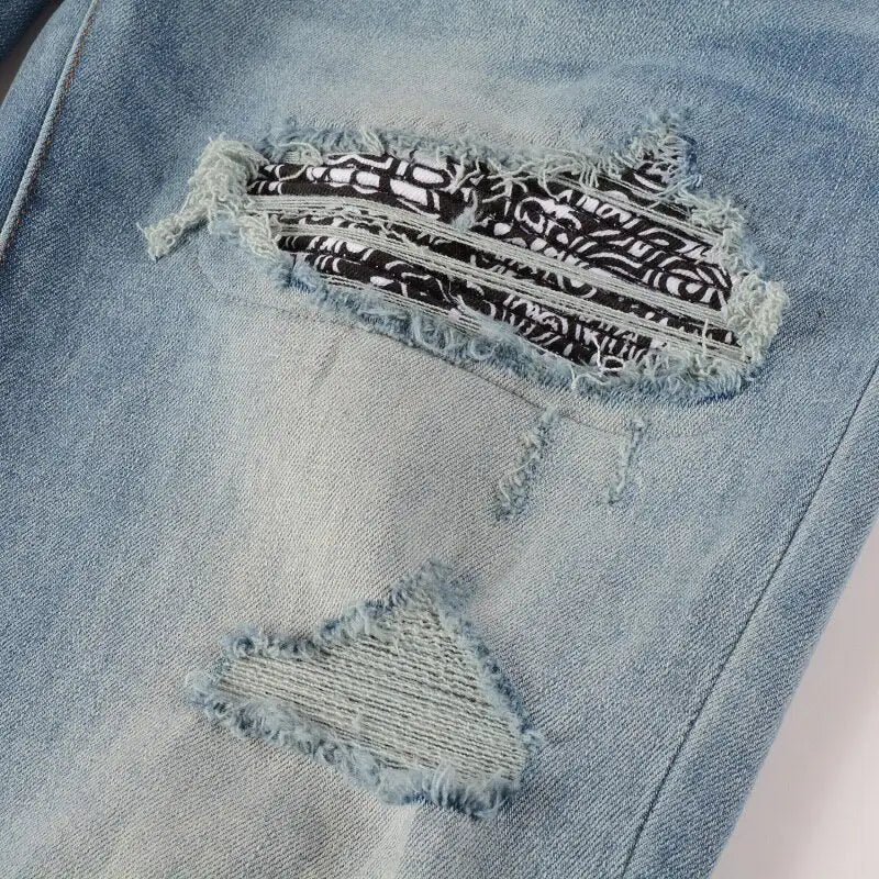 Distressed denim jeans with bandanna-inspired patterns and ripped detailing